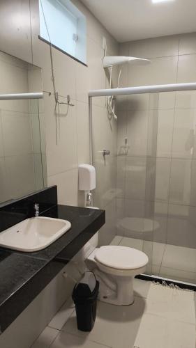 a bathroom with a sink and a toilet and a shower at pousada 3 Marias in Itacaré