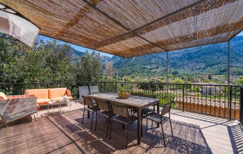 a patio with a table and chairs on a deck at Arbona Soller in Sóller