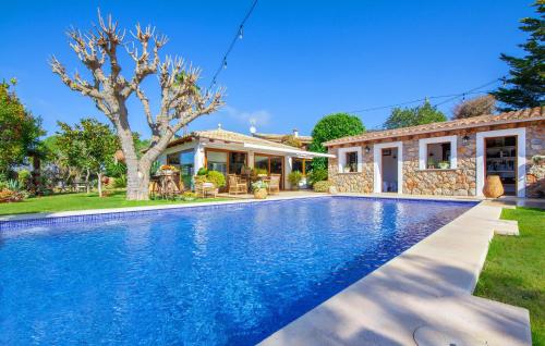 a villa with a swimming pool in front of a house at Can Sion in Esporlas