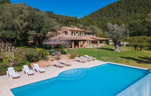 a villa with a swimming pool and a house at Sa Tafona in Esporles