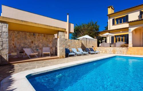 a villa with a swimming pool and a house at Ca Nostra in Cala Millor
