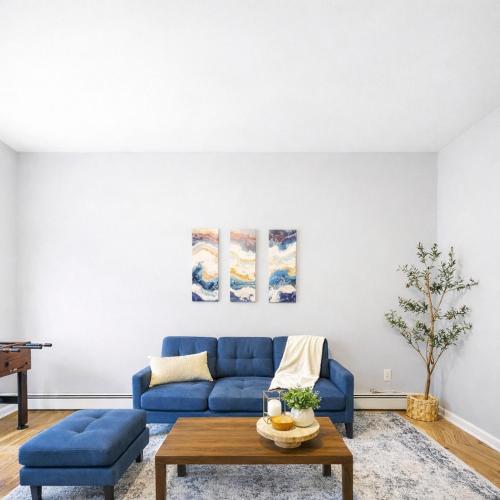 a living room with a blue couch and a table at Cozy up with me! Longer stays! Free parking in Troy