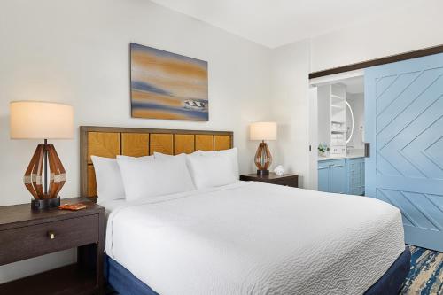 a bedroom with a large white bed and blue cabinets at Hyatt Vacation Club at Beach House in Key West