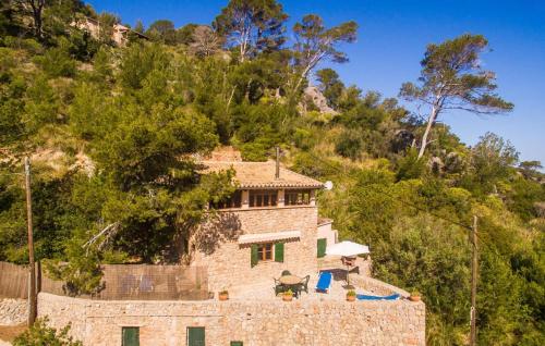 a stone house on a hill with trees at Antonio in Deia