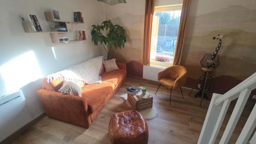 a living room with a couch and a guitar at Le Royal Billy in Dreux