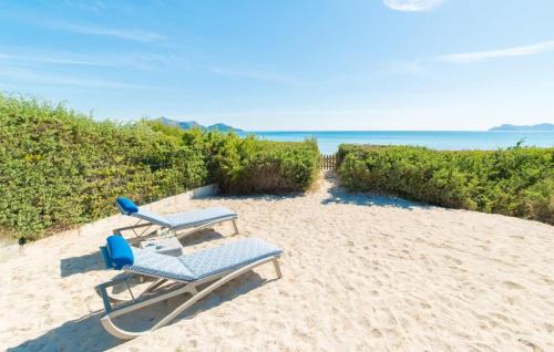 a beach chair sitting on the sand on the beach at Sa Platja in Playa de Muro