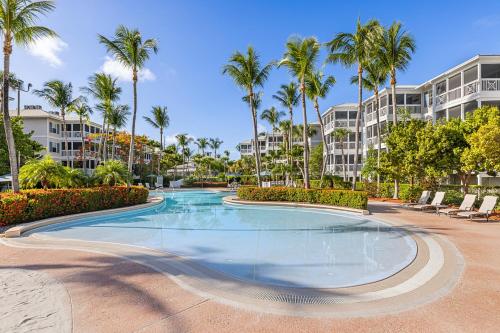 a swimming pool in a resort with palm trees at Hyatt Vacation Club at Beach House in Key West