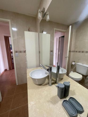 a bathroom with a sink and a toilet and a counter at Miramar2026 in Miramar