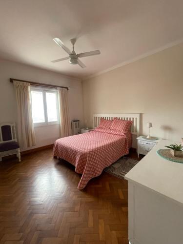 a bedroom with a bed and a ceiling fan at Miramar2026 in Miramar