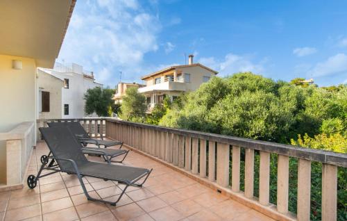 a row of chairs sitting on a balcony at Es Ganxo House in Porto Cristo