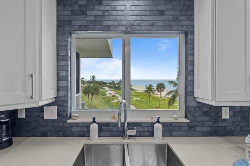 a kitchen sink with a window with a view of the ocean at Island Beach Club P4E in Sanibel
