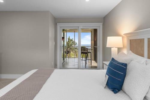 a bedroom with a bed and a view of the ocean at Island Beach Club P4E in Sanibel