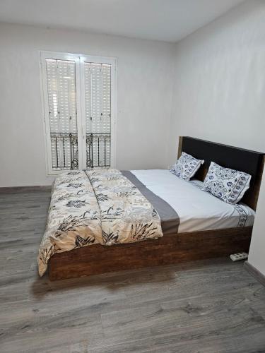 a bed in a bedroom with a large window at Riverfront Villa 069 in Terre Rouge
