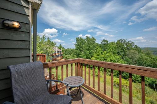 a balcony with a table and chairs on a deck at Après 18 by Railey Vacations in McHenry