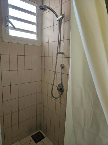 a shower in a bathroom with a window at Riverfront Villa 069 in Terre Rouge