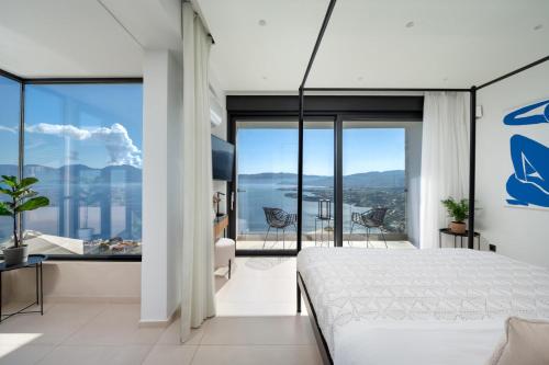 a bedroom with a bed and a view of the ocean at Majestic View Villas in Agios Nikolaos