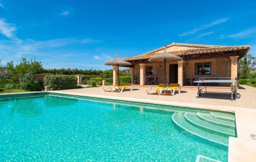 a villa with a swimming pool and a house at Ca Na Neus Pollenca in Pollença