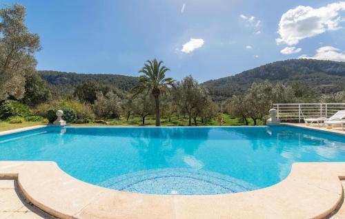 a swimming pool in a villa with mountains in the background at Sa Tafona in Esporles