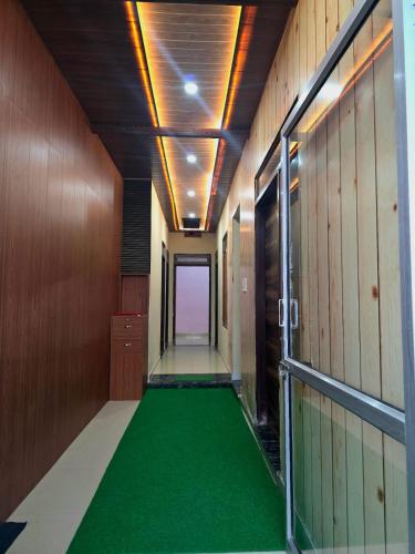 an empty hallway with a green floor in a building at Hotel Gopal Palace in Khātu