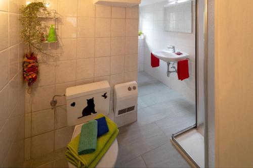 a small bathroom with a toilet and a sink at BnB "A la Crus" in Crana