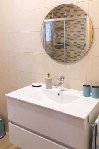 a bathroom with a white sink and a mirror at Encosta da Cabreira in Vieira do Minho