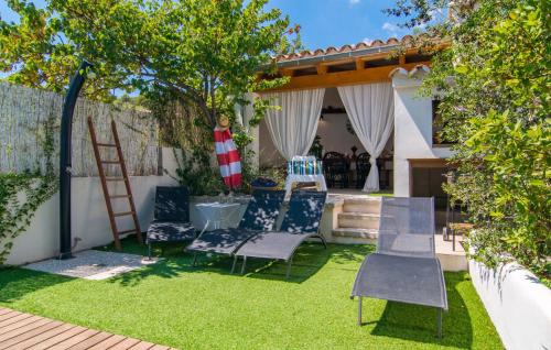 a yard with chairs and a table and a fence at Casa Gema in El Port de la Selva