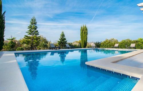 a large swimming pool with blue water at Ca Na Siona in Alcudia