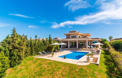 a large house with a swimming pool in the yard at Redrema in Llucmajor