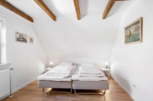 a bedroom with two beds in a attic at FY405-Millinge-Assensvej-422 in Faldsled