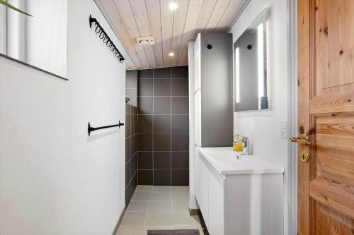 a bathroom with a white sink and a shower at FY405-Millinge-Assensvej-422 in Faldsled