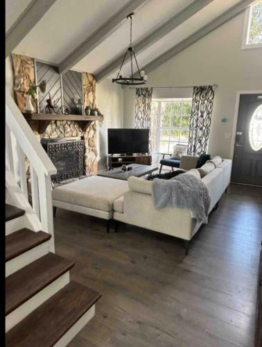 a living room with a couch and a piano at Central Perk Retreat | Heated Pool + Zoo 1 Block! in Tampa