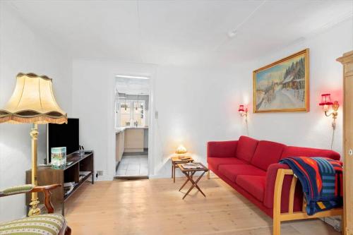 a living room with a red couch and a table at FY406-Faaborg-Bojestraede-4-A in Faaborg