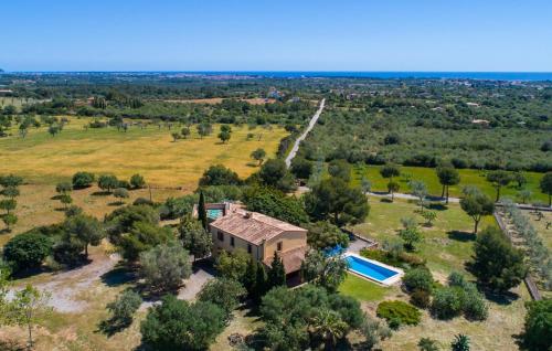an aerial view of a house with a pool in a field at Can Bernat in Cala Mendia