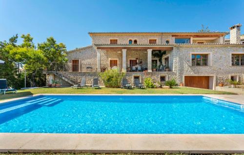 a villa with a swimming pool in front of a house at Turixant Dalt in El Port de la Selva