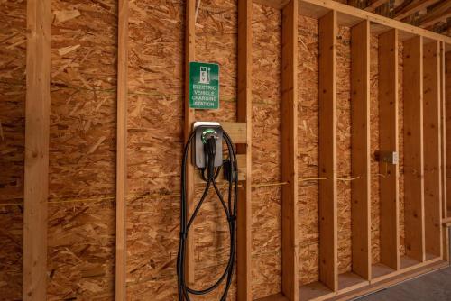 a shower in a room with wooden walls at Arcadia by Railey Vacations in McHenry
