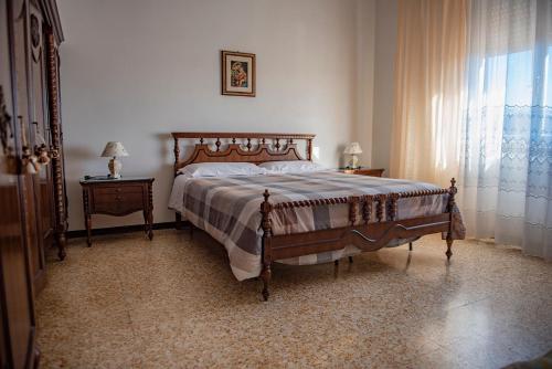 a bedroom with a bed and a window at Cav Costa degli Etruschi in San Vincenzo