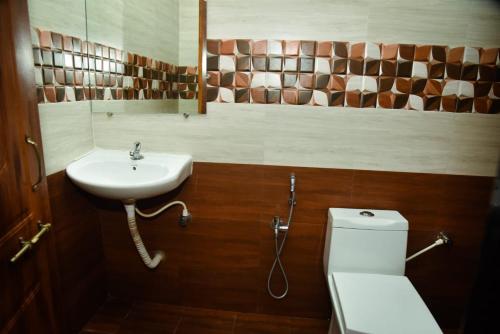 a bathroom with a sink and a toilet at Wayne Nest Calangute in Calangute