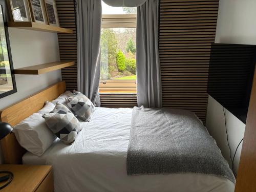a bedroom with a bed in front of a window at Ravelston in Edinburgh