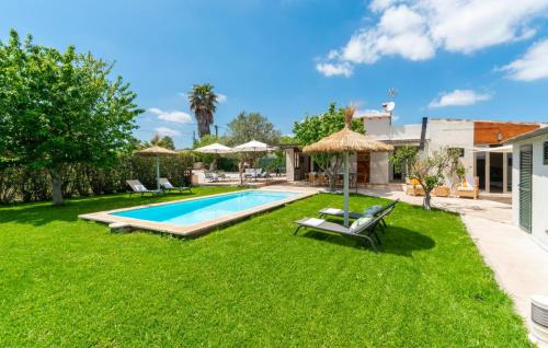 a backyard with a swimming pool and green grass at Es Collet De Manacor in Manacor
