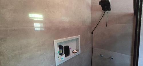 a bathroom with a shower with a mirror in it at Base Luz na Floresta in Manaus