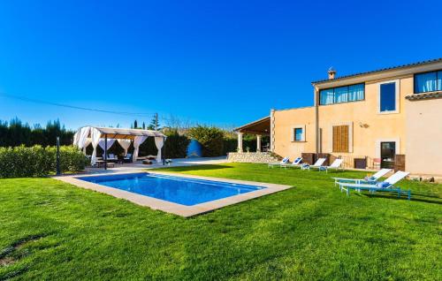 a backyard with a pool and a house at Finca Llum in Manacor