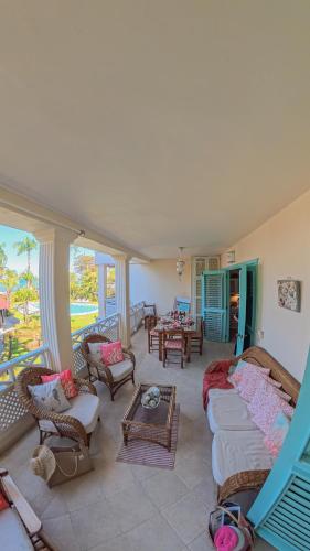 a living room with couches and chairs and a balcony at La Dolce Vita Beachfront Apt 9 in Las Terrenas