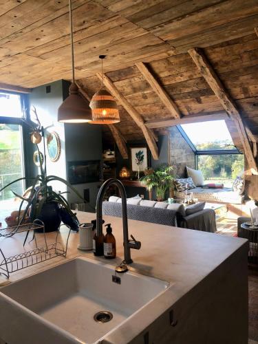 a kitchen counter with a sink in a room at La Grange de Timon in Laguiole