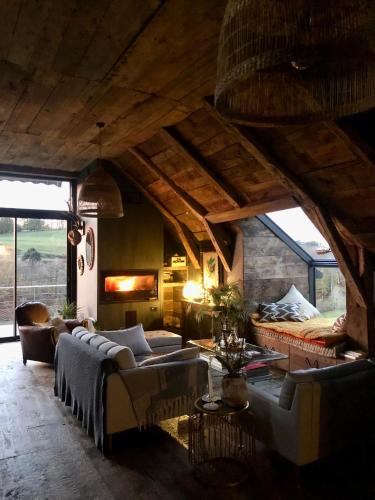 a living room with couches and a bed at La Grange de Timon in Laguiole
