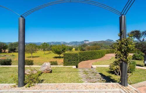 a garden with a metal arch with a pathway at Es Triquet in Binissalem