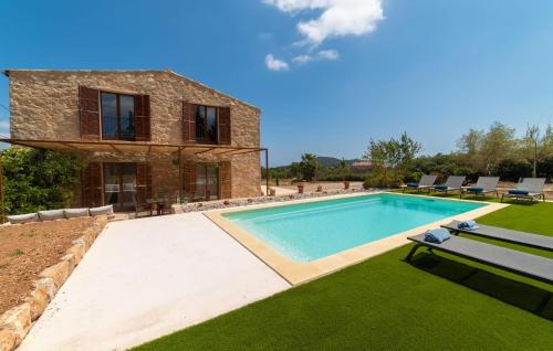 a swimming pool in front of a house at Son Cullera Petit in Son Servera