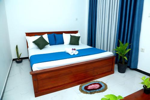 a bedroom with a bed with a stuffed animal on it at Induwara Beach Stay Thalalla in Delgalla