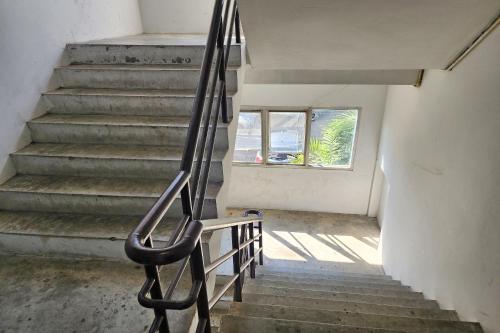 a stairway with a bench and a window at Toucan Garden in Samutprakarn