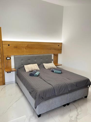 a bed with two pillows on it in a room at Apartma Rozi Deluxe in Koper