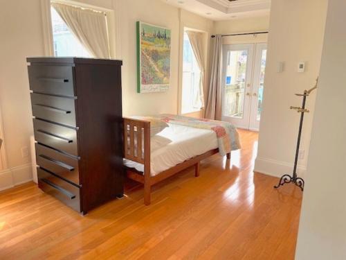 a bedroom with a dresser and a bed in a room at Water Street Condos - 110 and 204 Water Street in St. John's